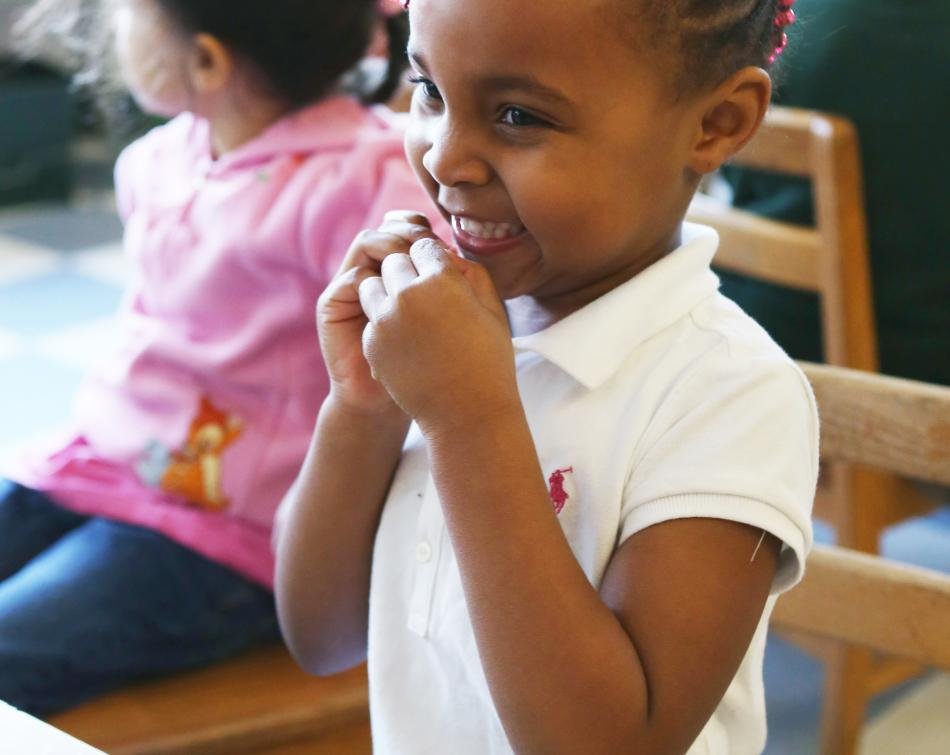 smiling girl eating a snack close up